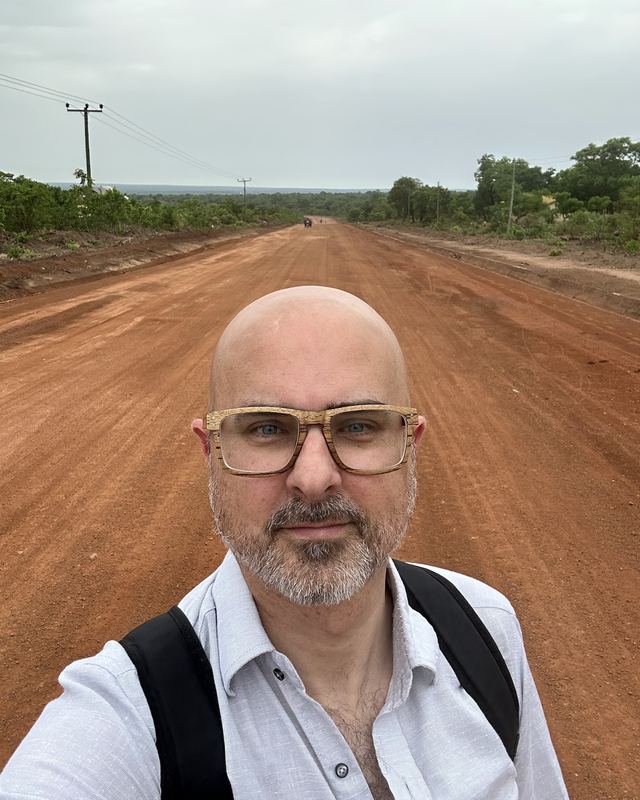 Gareth Brocklebank on a red dirt road in West Africa